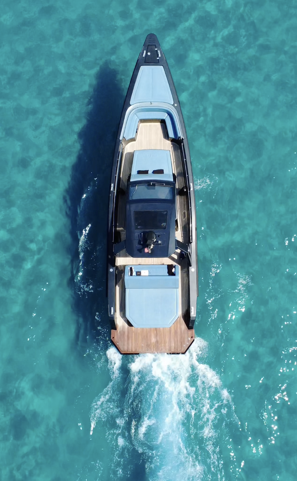 Aerial view of the yacht cruising turquoise water